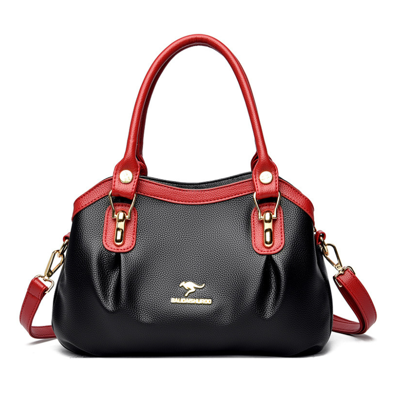 Color-block handbag featuring contrasting hues with gold-tone hardware accents
